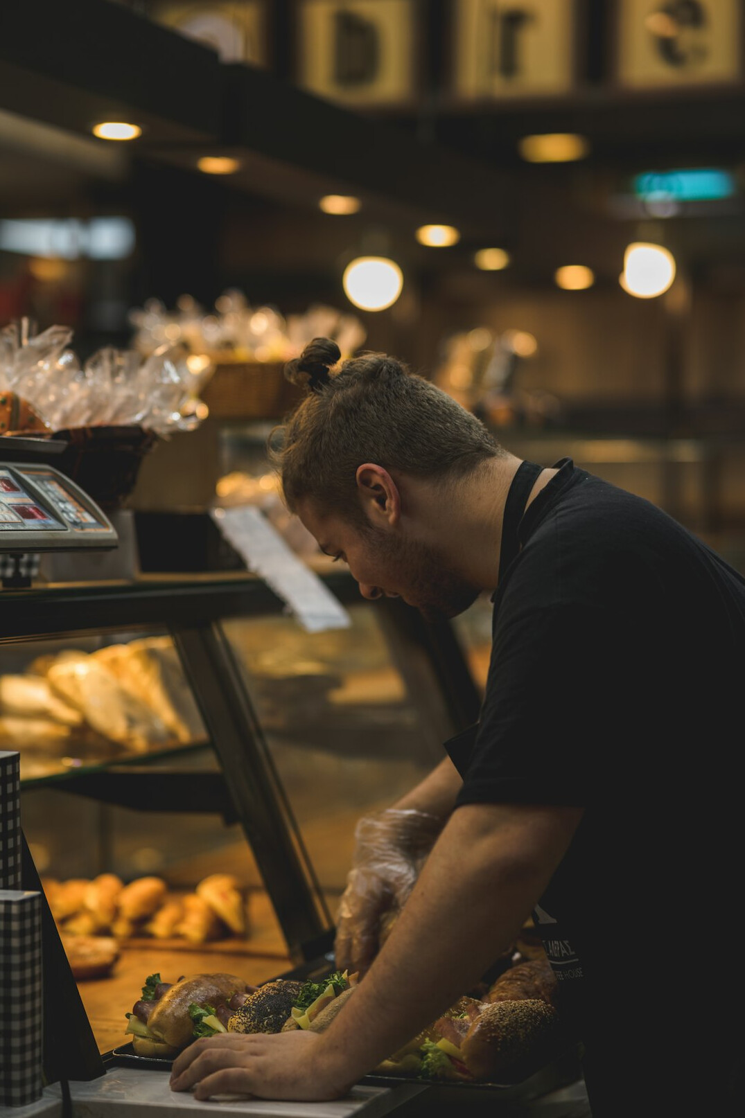 person buying bread at bakery