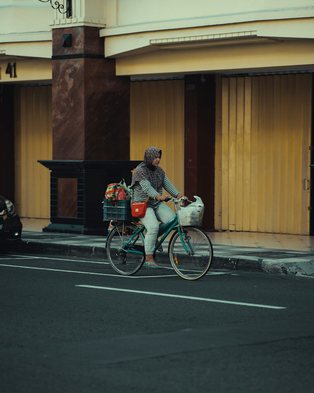 woman cycling with groceries