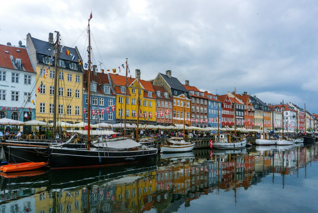 Colourful harbourfront street with bicycles parked along historic buildings