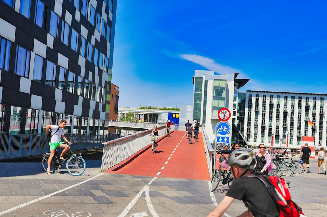 Two Danish cyclists riding side by side on a dedicated bike lane