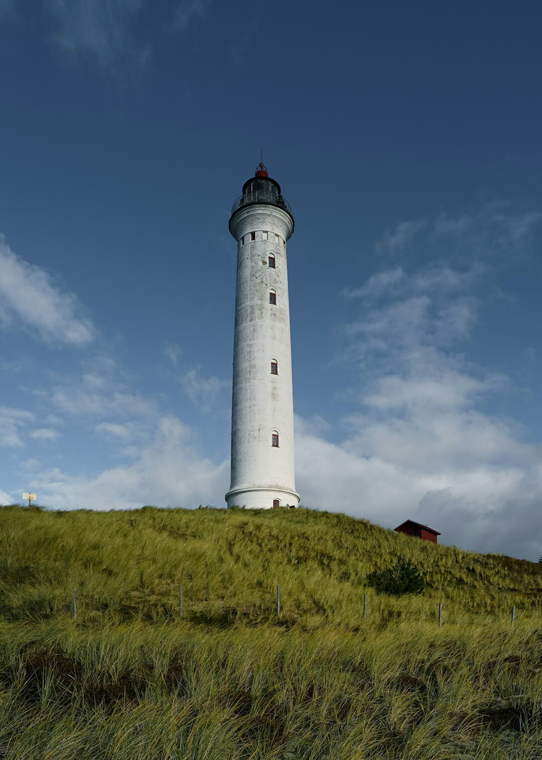 Red and white lighthouse on the Danish coastline